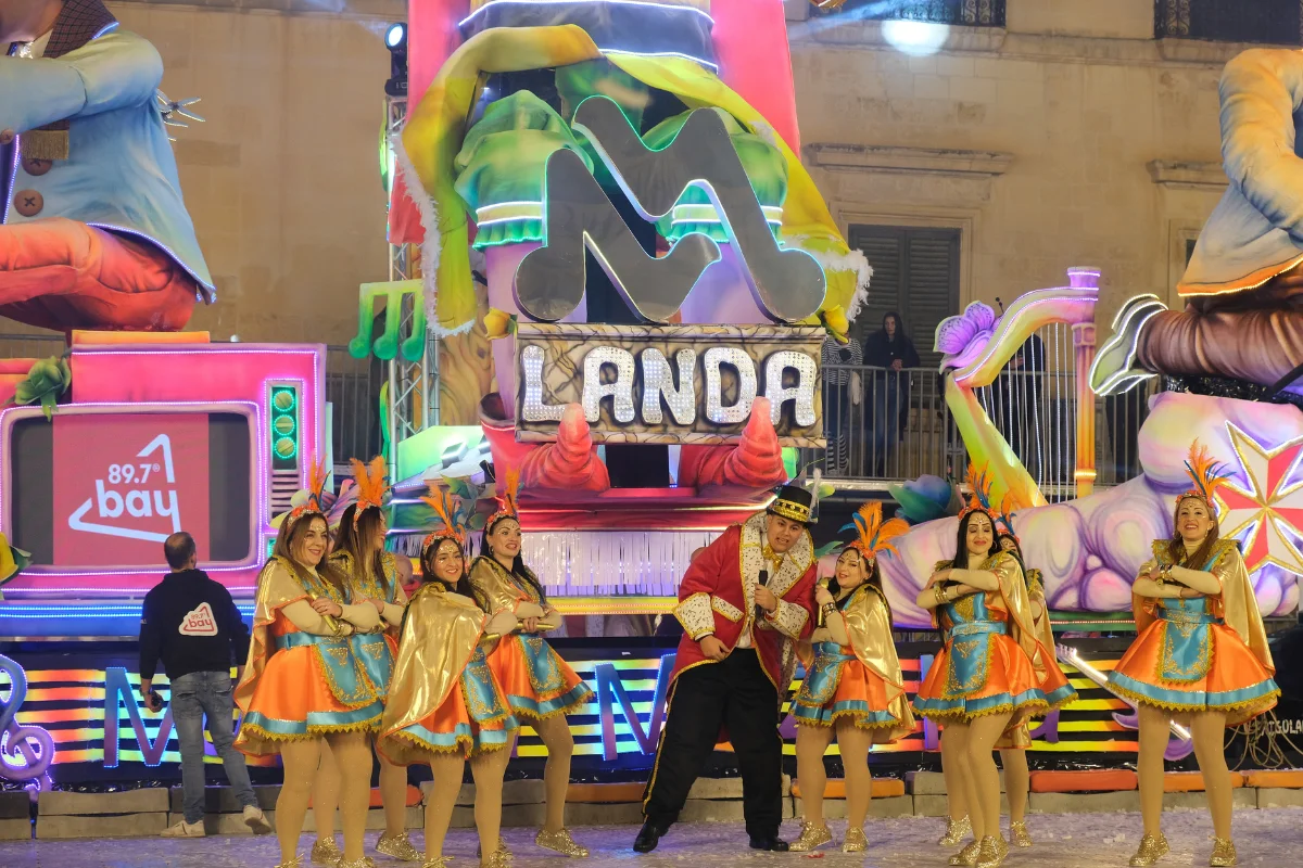 Malta Carnival itinerary evening parade float and costumed dancers in Valletta