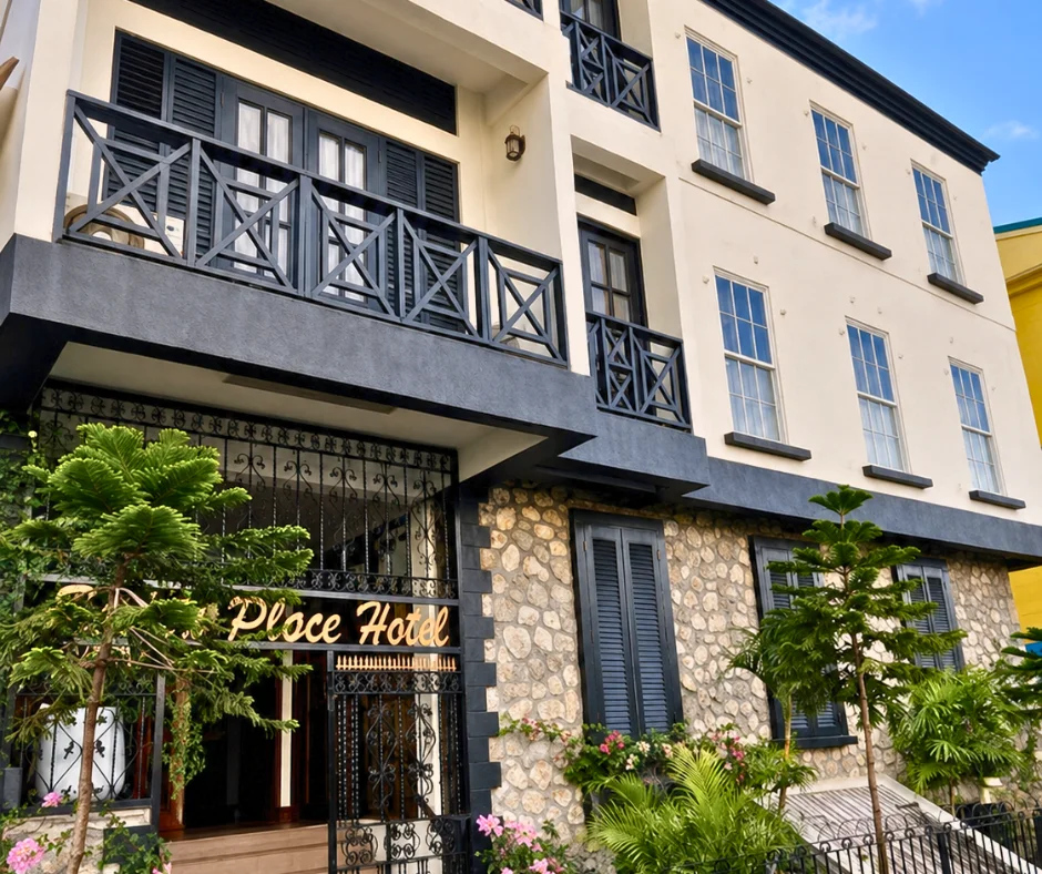 Stone and cream façade of Sutton Place Hotel in central Roseau, a boutique option among Dominica Carnival hotels.