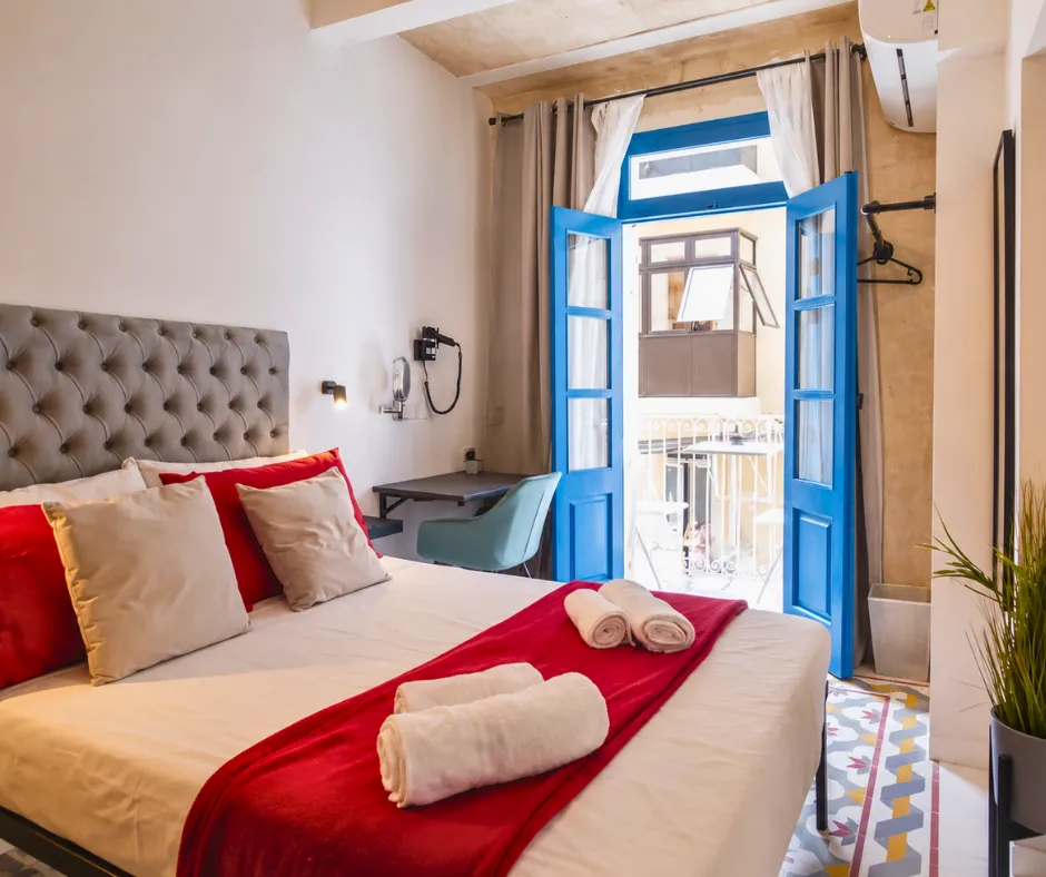 Private room with a balcony at Mandera's Boutique Suites and Dorms, a budget option among hotels for Malta Carnival