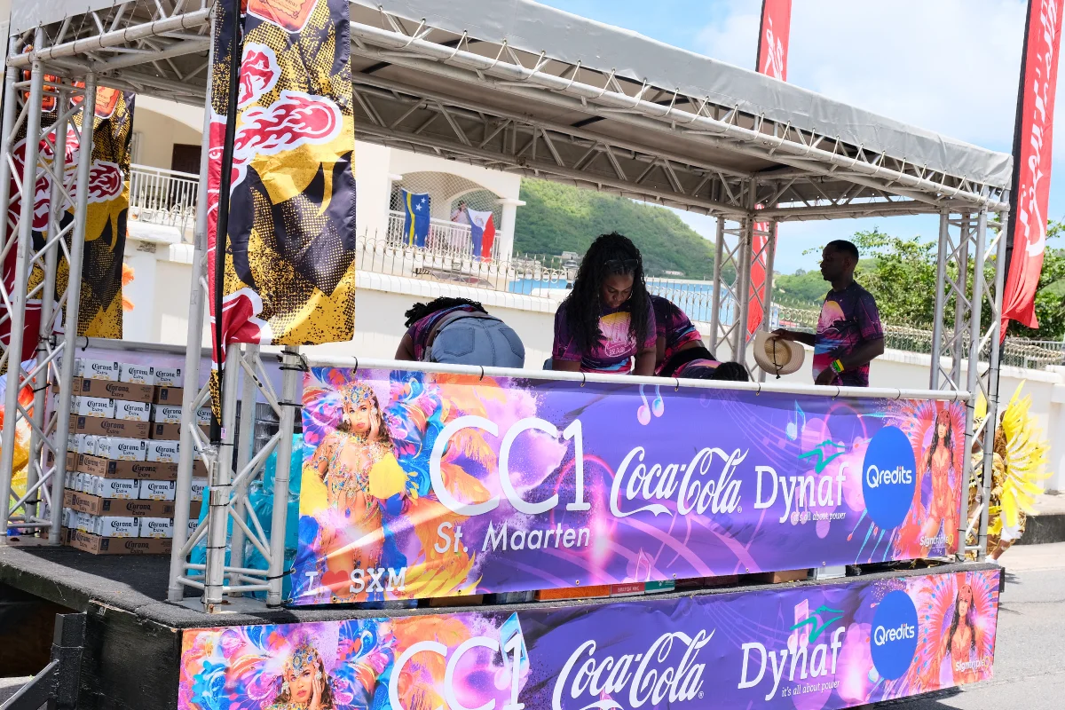 CC1 Coca-Cola and Dynaf branded carnival truck supporting the Sint Maarten Carnival parade with sponsors and crew. CC1 Coca-Cola Carnival Truck at SXM Carnival