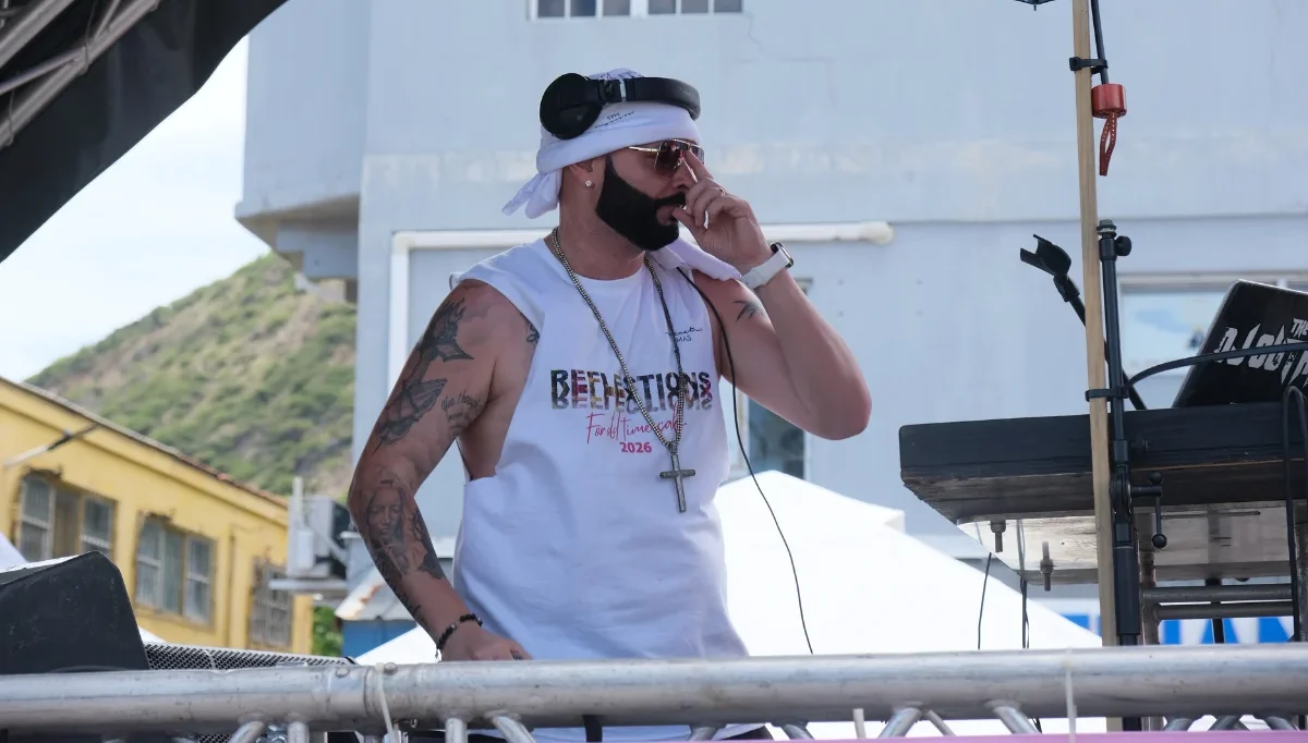 DJ performing on a mobile stage during Sint Maarten Carnival, providing entertainment for parade participants and spectators.