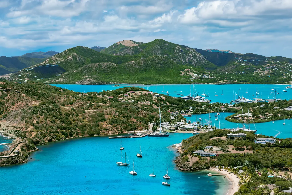 Wide panoramic view of Antigua's green hills, turquoise bays, and English Harbour from Shirley Heights.