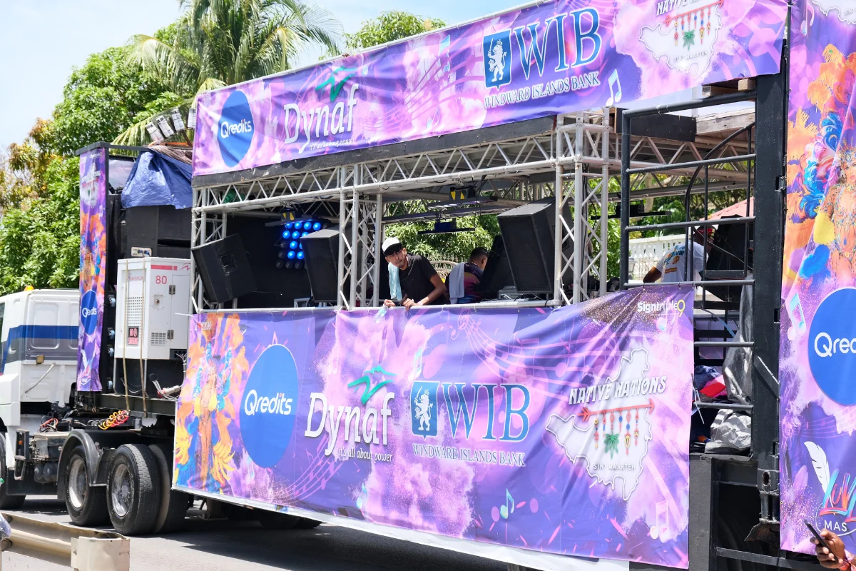 Sponsored music truck featuring Dynaf and Windward Islands Bank branding during the Sint Maarten Carnival parade.