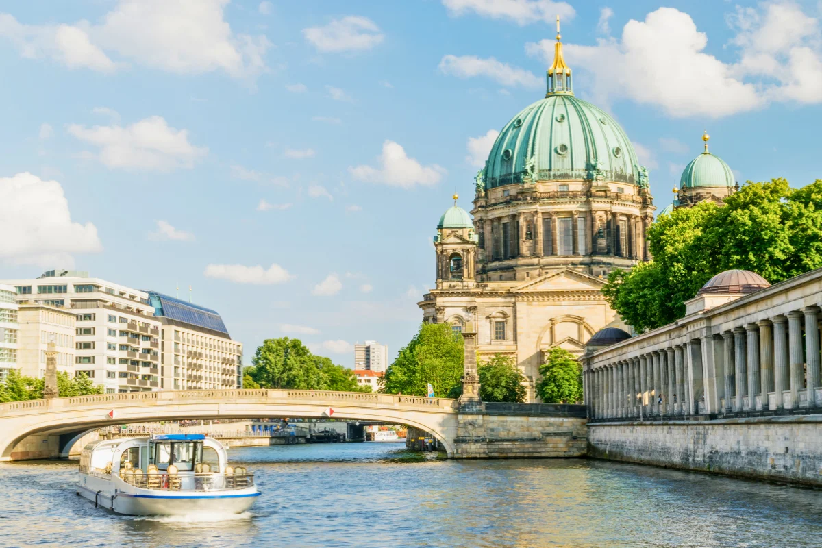 Sightseeing boat on the River Spree passing Berlin Cathedral and the Museum Island colonnade