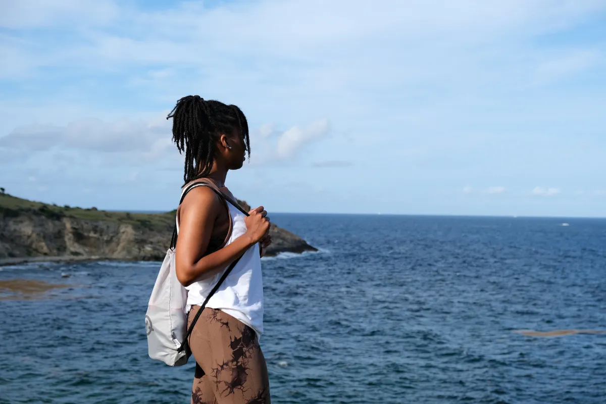 Carnival Vibez founder Shelley looking out over the Atlantic coastline on the Natural Pool hike in St. Maarten