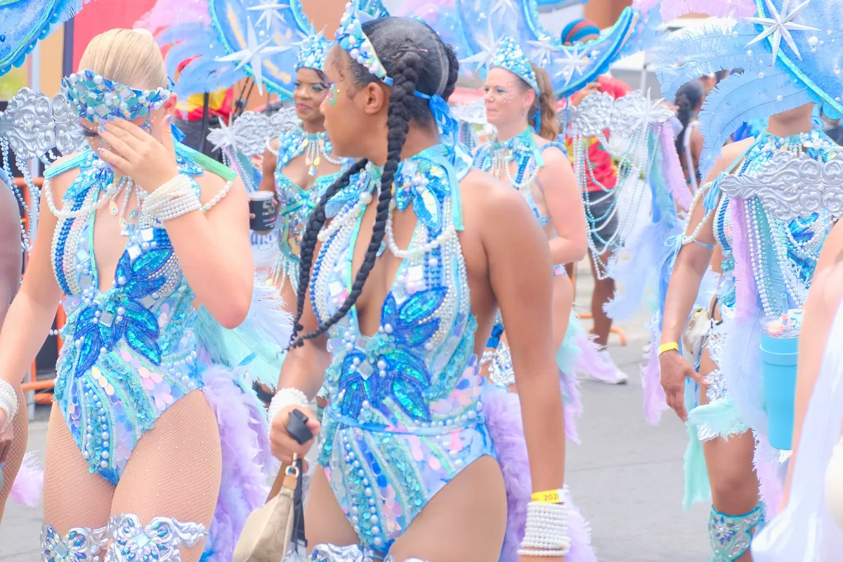 Mas band section in matching blue and silver costumes with gems and feathers on Carnival day