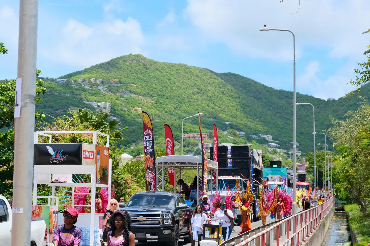 Band drinks carts, branded coolers and music trucks lined up along the road at St. Maarten Carnival as masqueraders pass