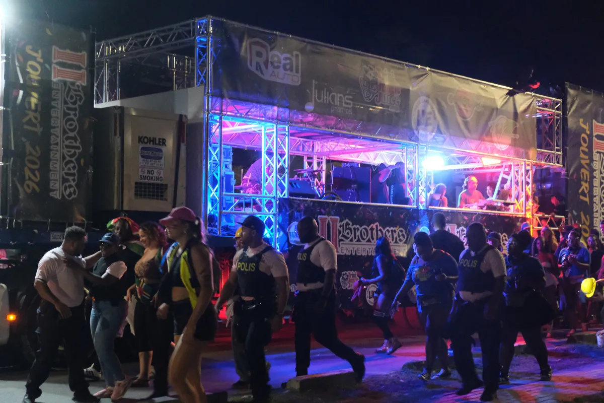 SXM Carnival Jouvert parade with illuminated music truck, revelers and police walking through Philipsburg