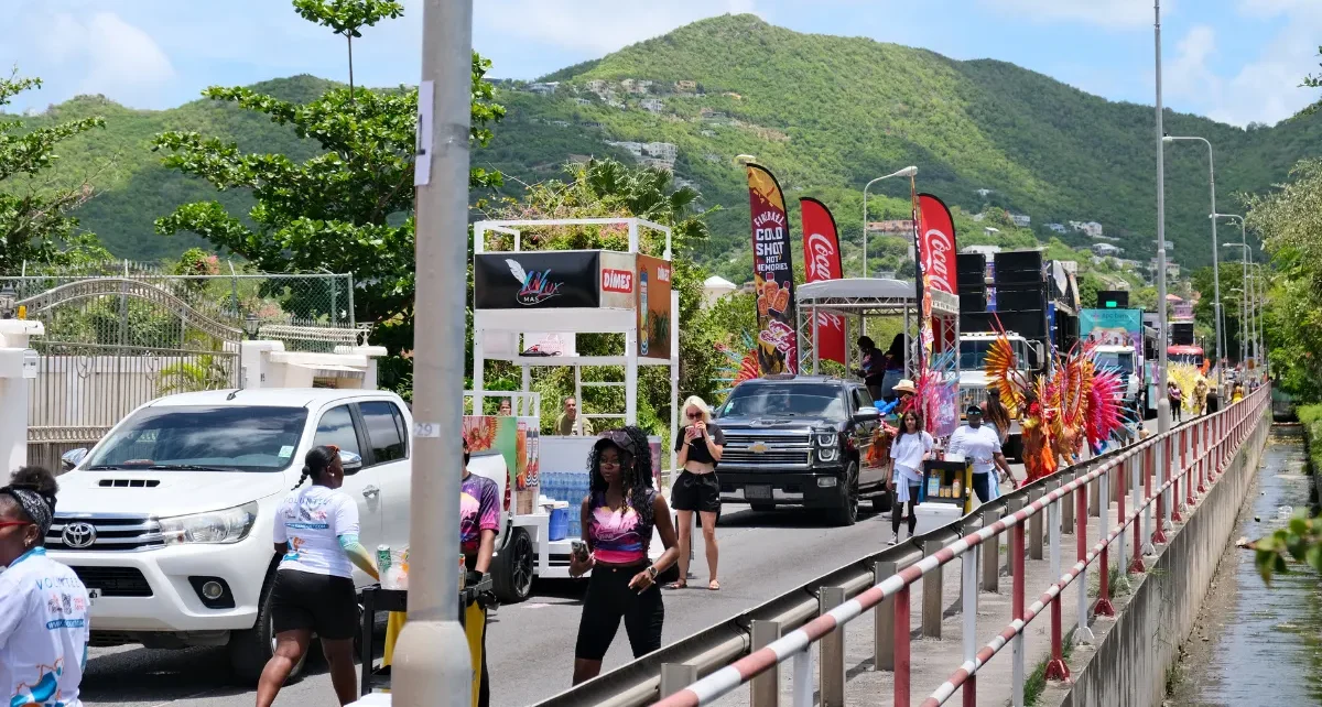 SXM Carnival parade procession with masqueraders, vehicles and music trucks traveling through Philipsburg