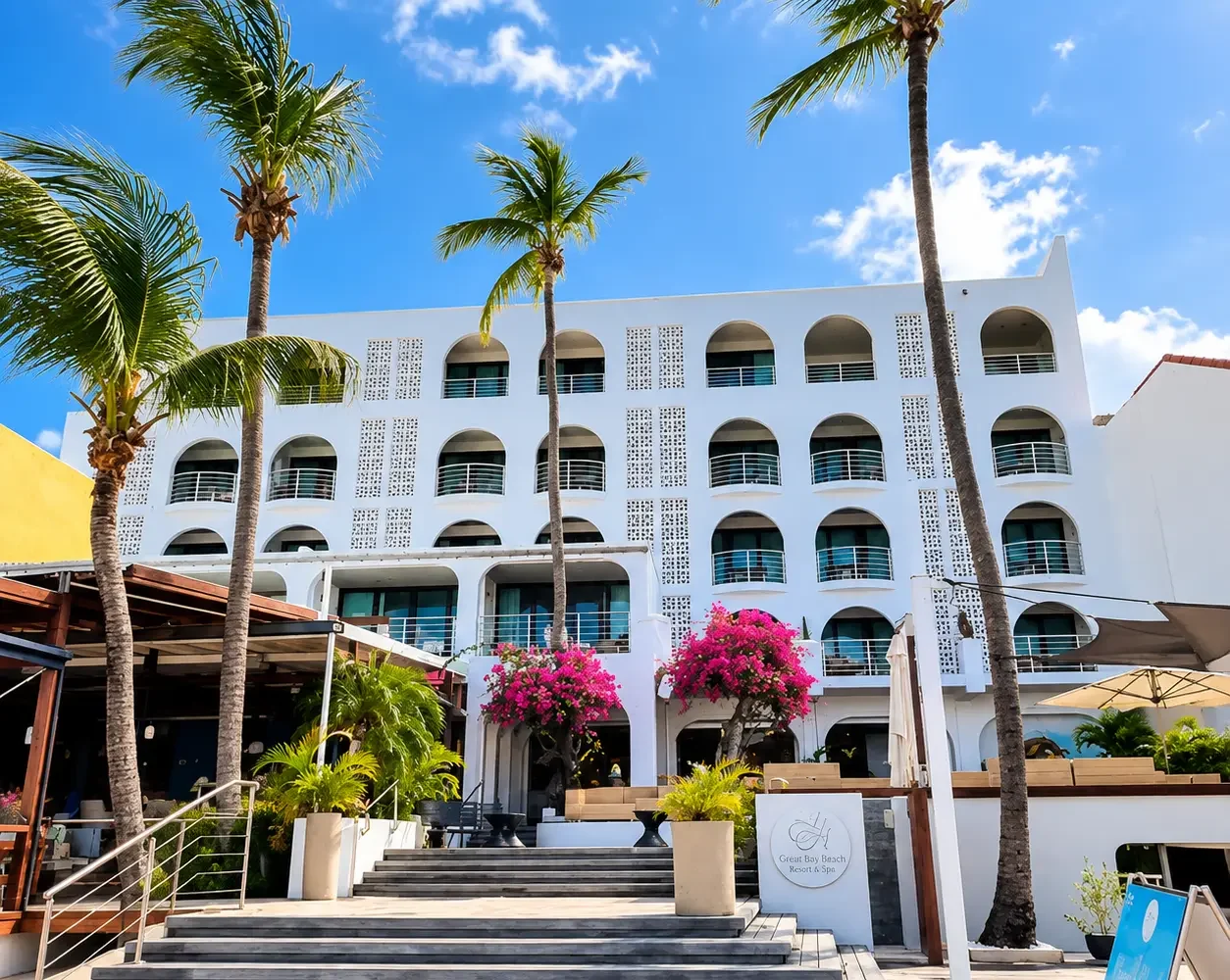 Holland House Beach Hotel in Philipsburg, St. Maarten, with palm trees and a sunny tropical entrance near SXM Carnival events